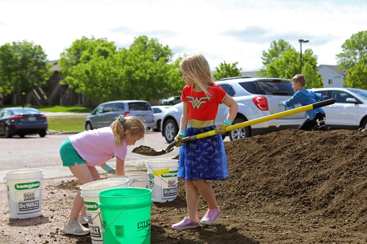 Many of the children at EmBe's childcare center were excited to use a shovel to move soil and dirt into the new garden beds on Thursday, May 26. EmBe is partnering with Ground Works to build teaching gardens that will teach children about nutrion and growing food.