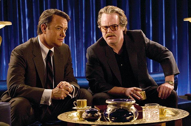 Tom Hanks portrays Charlie Wilson and Philip Seymore Hoffman portrays <u>Gust Avrakotos</u> in the film "Charlie Wilson's War." Photo via Wikimedia Commons