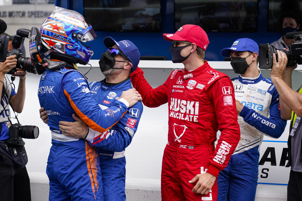 Scott Dixon, front left, of New Zealand, celebrates with teammates, Tony Kanaan, left center, of Brazil, Marcus Ericsson, right, center, of Sweden, and Alex Palou of Spain, after winning the pole during qualifications for the Indianapolis 500 auto race at Indianapolis Motor Speedway in Indianapolis, Sunday, May 23, 2021. (AP Photo/Michael Conroy)