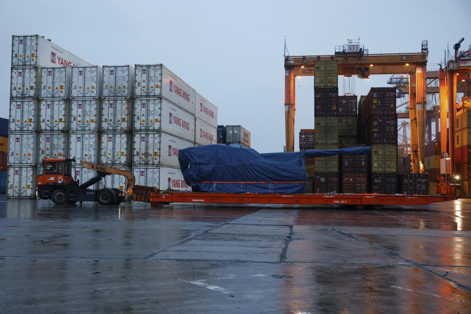 A worker transports South Korean Thunder K9 howitzer in the Polish Navy port of Gdynia, Poland, Tuesday, Dec. 6, 2022. Poland's President Andrzej Duda and the defense minister on Tuesday welcomed the first delivery of tanks and howitzers from South Korea, hailing the swift implementation of a deal signed in the summer in the face of the war in neighbouring Ukraine. (AP Photo/Michal Dyjuk)