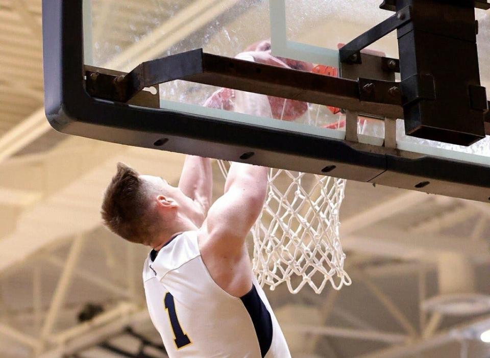 Airport's Joel Westaway dunks off an alley oop from Brett Moore during a 79-49 win over Jefferson Friday night.