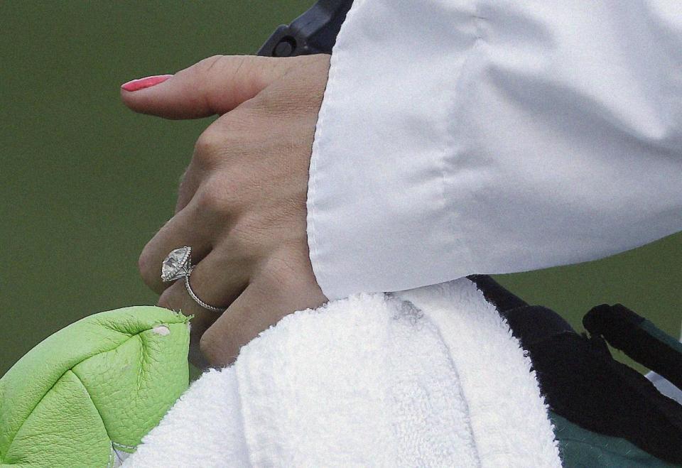 Tennis player Caroline Wozniacki wears her engagement ring from her fiancee Rory McIlroy, of Northern Ireland, during the par three competition at the Masters golf tournament Wednesday, April 9, 2014, in Augusta, Ga. (AP Photo/Darron Cummings)