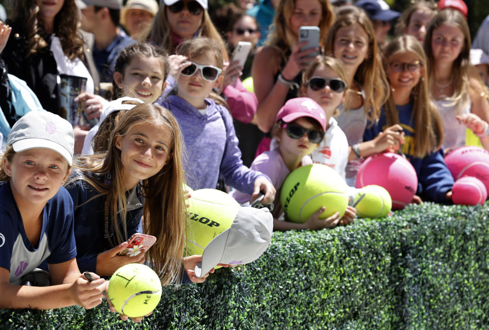 Tennis fans wait for autographs after Andreja Klepac and Magda Linette won the doubles title against Lucie Hradecka and Sania Mirza in finals action at the Charleston Open tennis tournament in Charleston, S.C., Sunday, April 10, 2022. (AP Photo/Mic Smith)