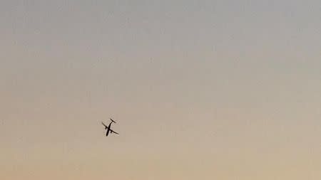 A Horizon Air Bombardier Dash 8 Q400, reported to be hijacked, flies over University Place, Washington, the U.S., before crashing in the South Puget Sound, August 10, 2018 in this still image taken from a video obtained from social media. John Waldron/via REUTERS