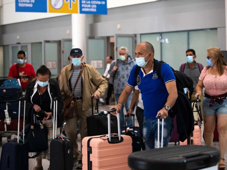 People wait at the arrivals section of Terminal 1 of Toronto Pearson International Airport on Thursday, June 9, 2022.  (Esteban Cuevas/CBC - image credit)