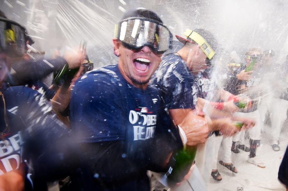 Sep 19, 2024; Cleveland, Ohio, USA; Cleveland Guardians second baseman Andres Gimenez, middle, celebrates with teammates after the Guardians beat the Minnesota Twins and clinched a playoff berth at Progressive Field. Mandatory Credit: Ken Blaze-Imagn Images