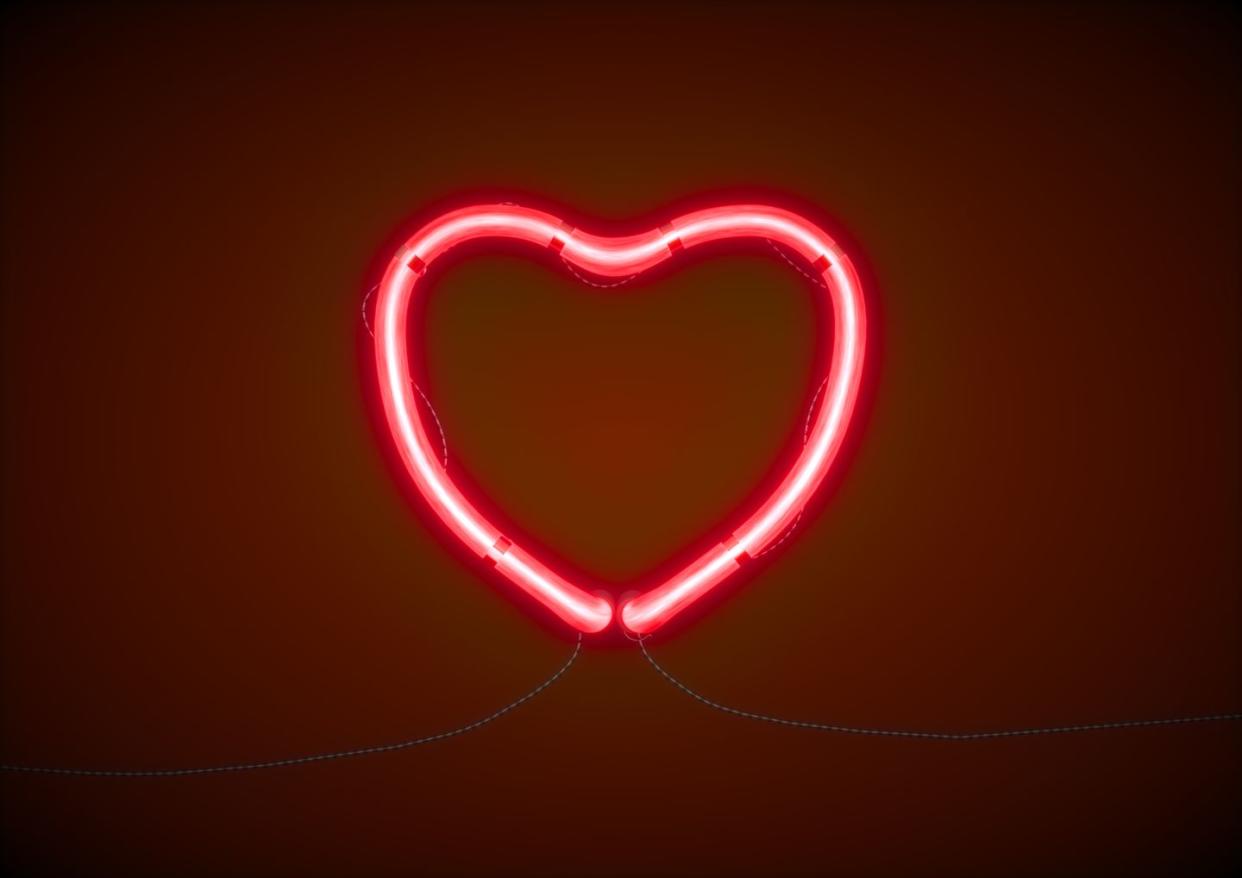 red heart shape illuminated light against wall