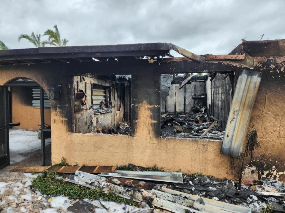 This home on Isles of Capri burned when an auto battery shorted out under the rising water and the car exploded, according to neighbors.