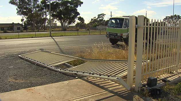 The men allegedly smashed through this gate with a stolen truck. Photo: 7News.