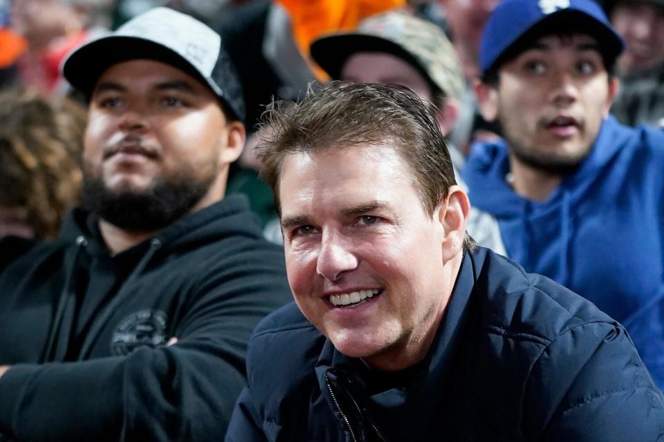 Tom Cruise smiles during Game 2 of a baseball National League Division Series between the San Francisco Giants and the Los Angeles Dodgers