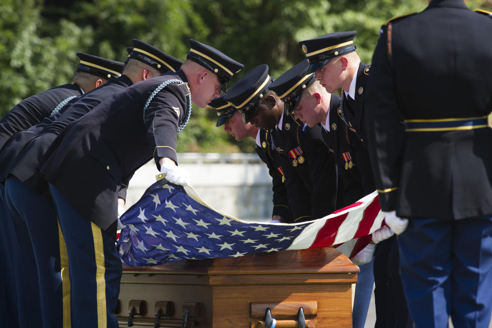 The 3rd Infantry Regiment, also known as the Old Guard, casket teams stretch the American flag over the casket containing the remains of one of two unknown Civil War Union soldiers to their grave at Arlington National Cemetery in Arlington, Va.,Thursday, Sept. 6, 2018. The soldiers were discovered at Manassas National Battlefield and will be buried in Section 81. Arlington National Cemetery opened the new section of gravesites with the burial. (AP Photo/Cliff Owen)