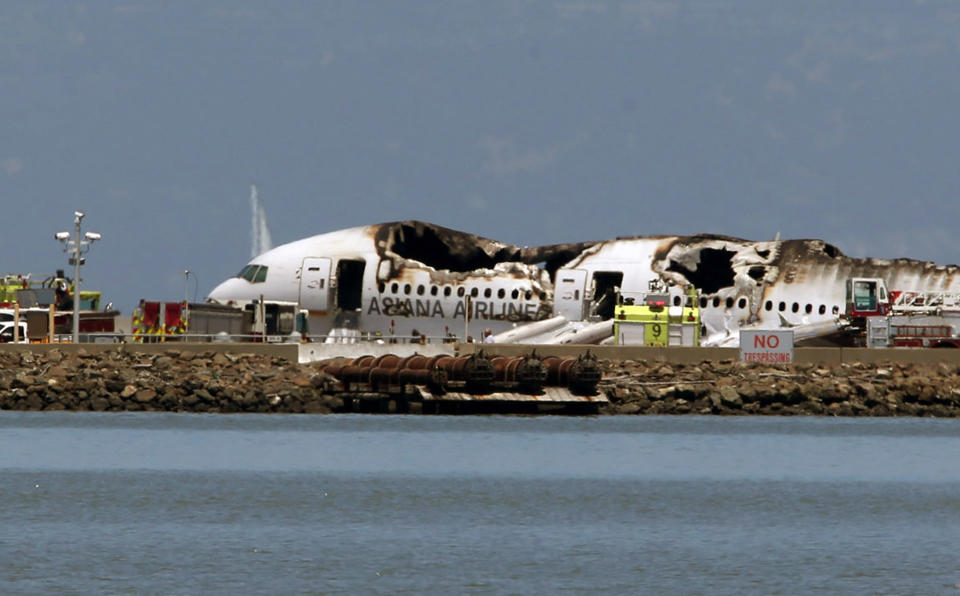 SAN FRANCISCO, CA - JULY 6:  (EDITORS NOTE: Retransmission with alternate crop.)  A Boeing 777 airplane lies burned on the runway after it crashed landed at San Francisco International Airport July 6, 2013 in San Francisco, California. A passenger aircraft from Asiana Airlines coming from Seoul, South Korea crashed landed while on it's landing decent. No word so far on injuries or deaths. (Photo by Justin Sullivan/Getty Images)