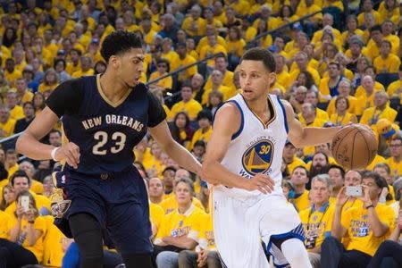 April 18, 2015; Oakland, CA, USA; Golden State Warriors guard Stephen Curry (30) dribbles the basketball against New Orleans Pelicans forward Anthony Davis (23) during the third quarter in game one of the first round of the NBA Playoffs at Oracle Arena. Kyle Terada-USA TODAY