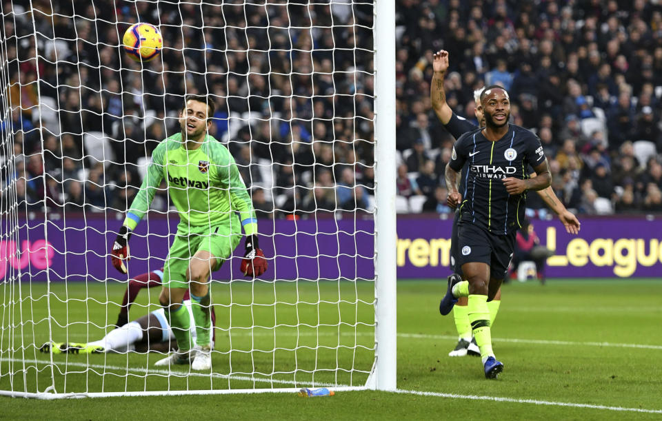 West Ham United goalkeeper Lukasz Fabianski, left, appears dejected as Manchester City's Raheem Sterling celebrates scoring his side's second goal of the game during their English Premier League soccer match at The London Stadium, London, Saturday, Nov 24, 2018. (Dominic Lipinski/PA via AP)