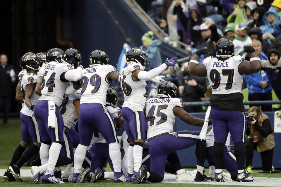 Baltimore Ravens players take part in a group photo touchdown celebration after cornerback Marlon Humphrey recovered a fumble and ran for a touchdown during the second half of an NFL football game against the Seattle Seahawks, Sunday, Oct. 20, 2019, in Seattle. (AP Photo/John Froschauer)