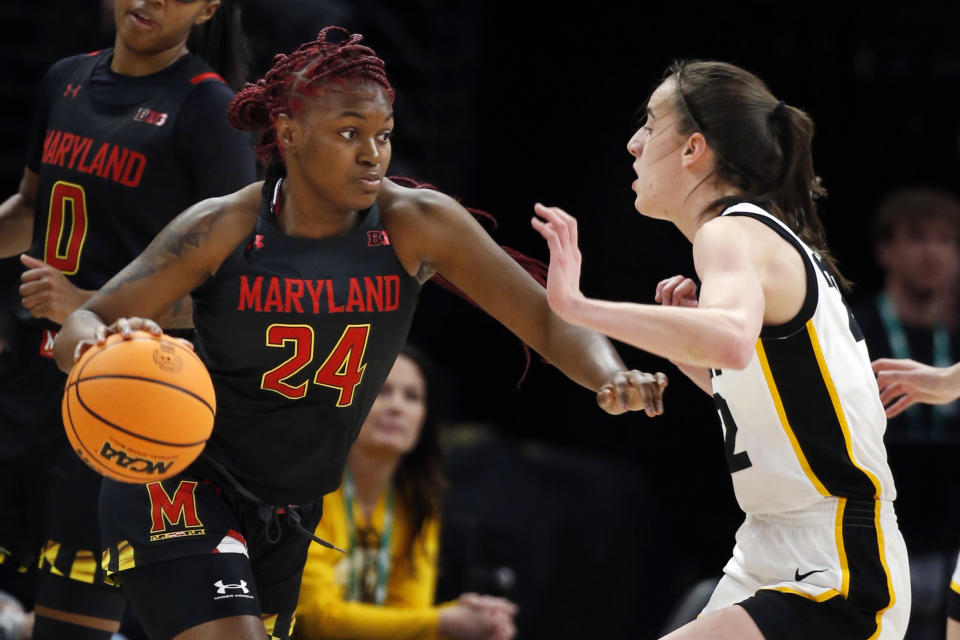 Maryland guard Bri McDaniel (24) dribbles around Iowa guard Caitlin Clark, right, in the first half of an NCAA college basketball game at the Big Ten women's tournament Saturday, March 4, 2023, in Minneapolis. (AP Photo/Bruce Kluckhohn)