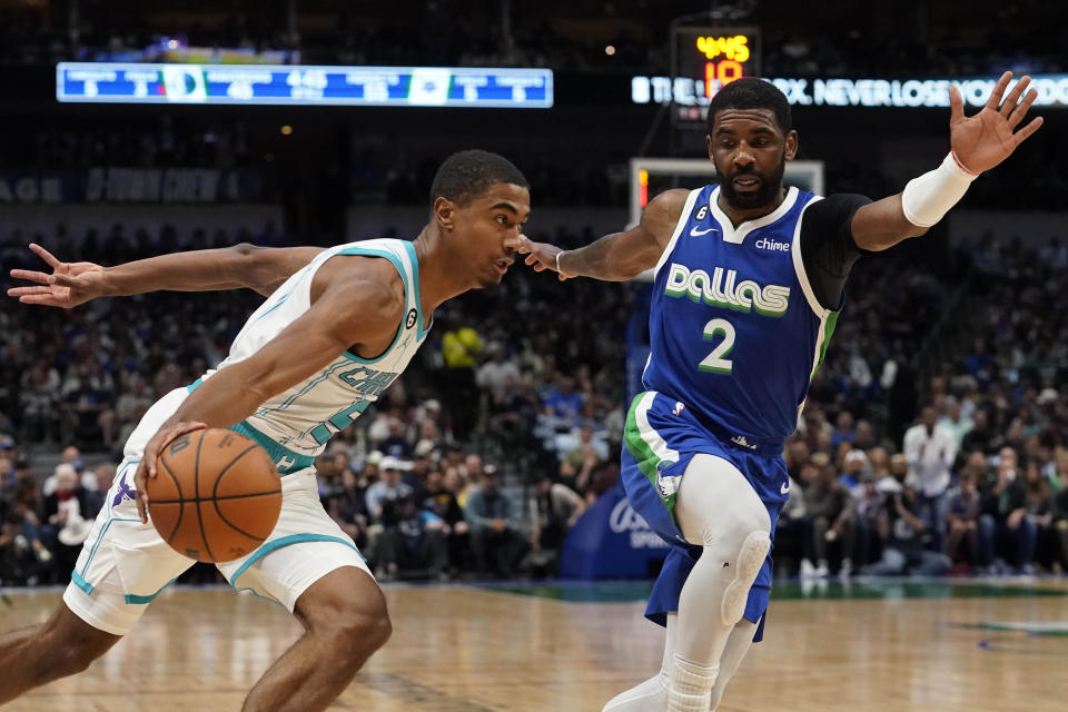 Charlotte Hornets guard Theo Maledon, left, drives against Dallas Mavericks guard Kyrie Irving (2) during the first half of an NBA basketball game in Dallas, Friday, March 24, 2023. (AP Photo/LM Otero)