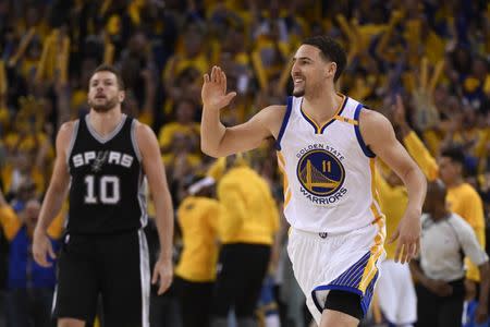 May 14, 2017; Oakland, CA, USA; Golden State Warriors guard Klay Thompson (11) celebrates in front of San Antonio Spurs forward David Lee (10) during the third quarter in game one of the Western conference finals of the 2017 NBA Playoffs at Oracle Arena. The Warriors defeated the Spurs 113-111. Mandatory Credit: Kyle Terada-USA TODAY Sports