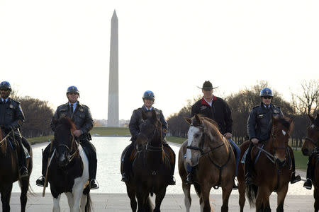 New Interior Secretary Ryan Zinke (2nd from R) rides on horseback with a U.S. Park Police horse mounted unit while reporting for his first day of work at the Interior Department in Washington, U.S., March 2, 2017. Tami Heilemann/Department of Interior/Handout via REUTERS