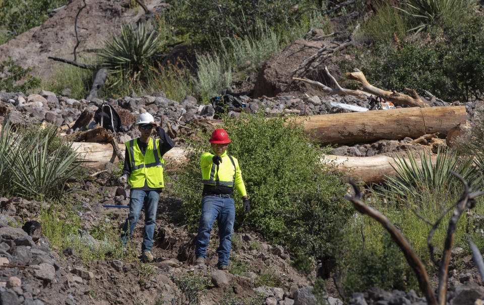 Contractors work on waterway restoration in Santa Clara Canyon in northern New Mexico, Tuesday, Aug. 23, 2022. The canyon, part of Santa Clara Pueblo, remains closed to the public while its habitat is being restored after devastating wildfires and flash floods. (AP Photo/Andres Leighton)