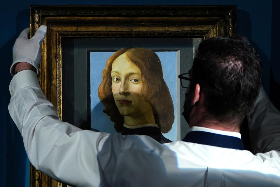 A worker at Sotheby's auctions puts Sandro Botticelli's 
