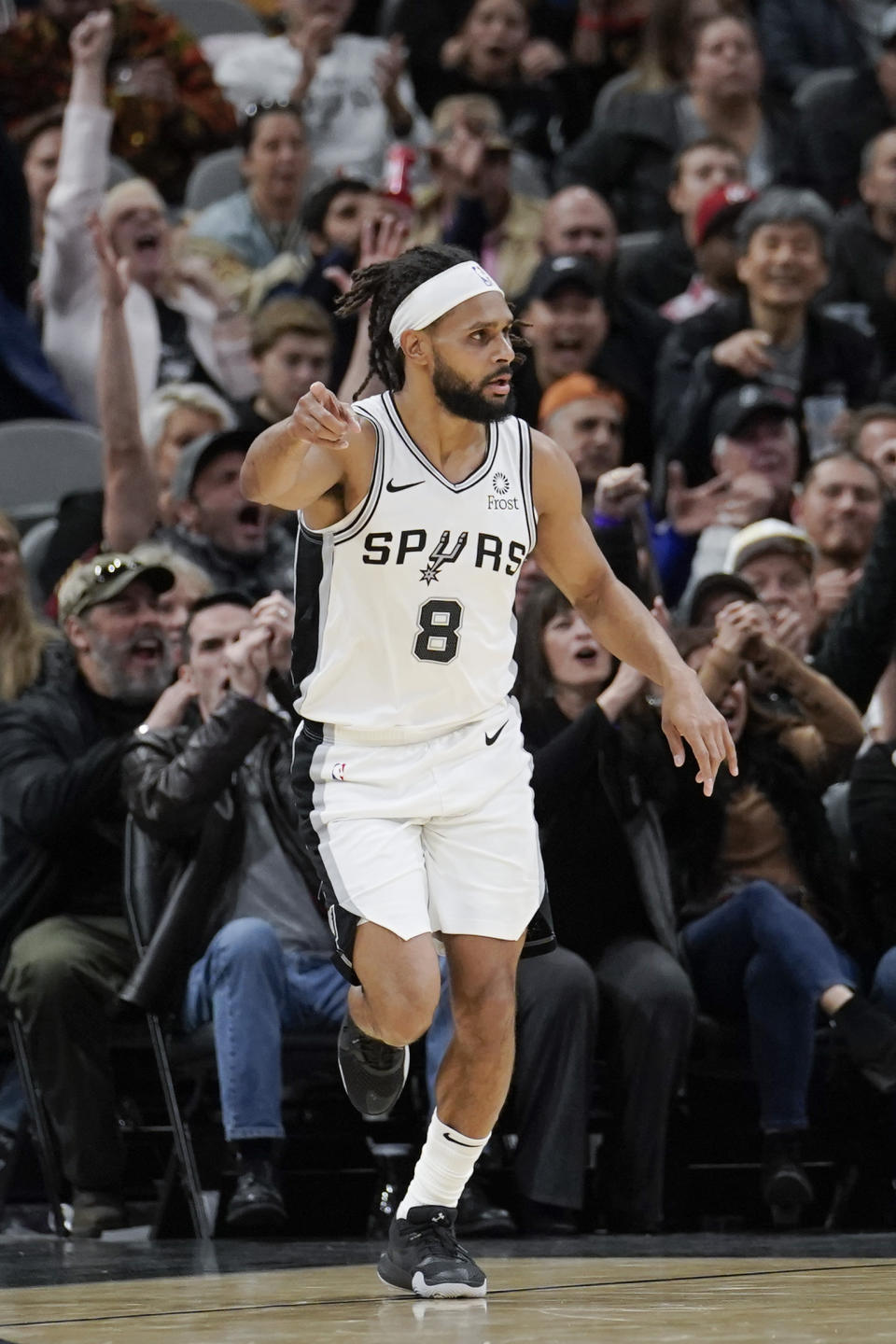 San Antonio Spurs' Patty Mills celebrates a 3-point basket during the second half of the team's NBA basketball game against the Brooklyn Nets, Thursday, Dec. 19, 2019, in San Antonio. San Antonio won 118-105. (AP Photo/Darren Abate)