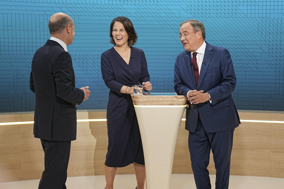 From left, Chancellor candidates Olaf Scholz (SPD), Annalena Baerbock (Green Party) and Armin Laschet (CDU) stand in the TV studio in Berlin, Sunday, Sept. 12, 2021. With two weeks left before Germany’s national election, the three candidates for chancellorship are facing off Sunday in the second of three televised election debates. (Michael Kappeler/Pool via AP)