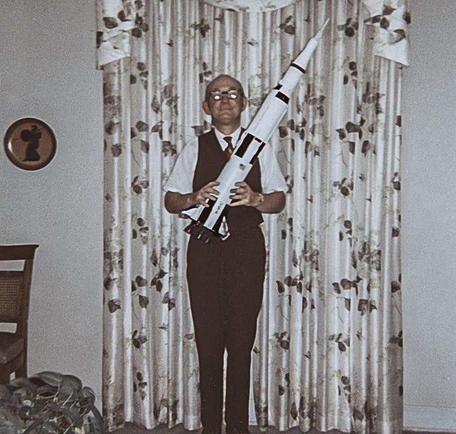 This June 1969 photo made by Frank Schramm shows his father, Frank, holding a model of a Saturn V rocket. The junior Schramm had an utter fascination with the moon landing ever since the Apollo 11 mission. He and his family even met Buzz Aldrin in 2016 when the former astronaut returned to Montclair to celebrate his old middle school being renamed Buzz Aldrin Middle School. (Frank Schramm via AP)