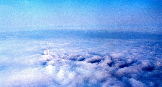 The photo taken from a plane shows the Twin Towers peeking out of clouds. Photo: Katie Weisberger