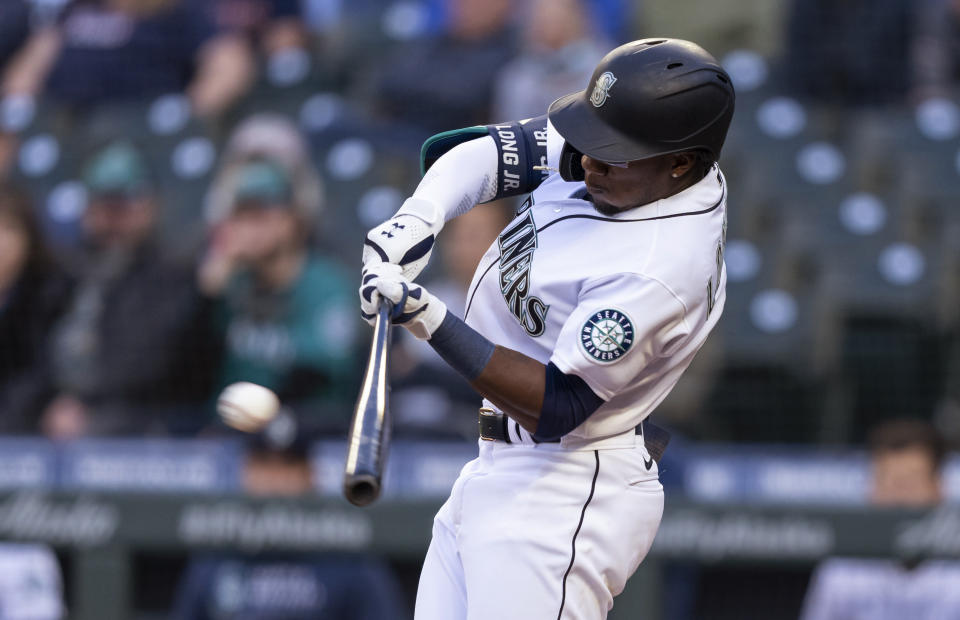 Seattle Mariners' Shed Long hits a three-run triple off of Minnesota Twins starting pitcher J.A. Happ during the second inning of a baseball game Tuesday, June 15, 2021, in Seattle. (AP Photo/Stephen Brashear)