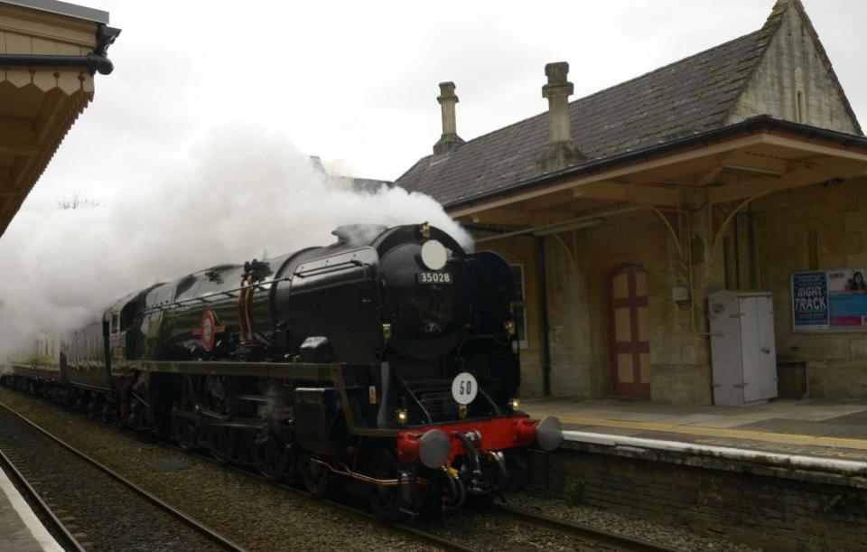 Wiltshire Times: Clan Line steams through Bradford on Avon station at speed on its 50th anniversary journey from London Victoria to Bath. Image: Trevor Porter 70012-5