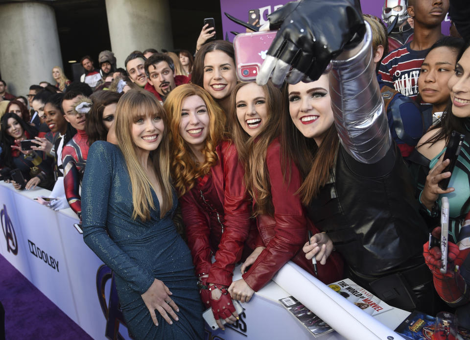 Elizabeth Olsen, left, takes a selfie with fans as she arrives at the premiere of "Avengers: Endgame" at the Los Angeles Convention Center on Monday, April 22, 2019. (Photo by Chris Pizzello/Invision/AP)