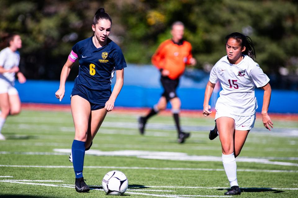 Lourdes' Grace Morra, left, kicks the ball during the girls Section 9 Class B championship soccer game in Middletown on Saturday, October 29, 2022.