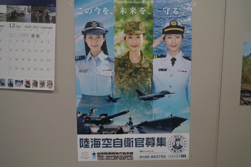 <p>A recruitment poster for the Self-Defense Forces featuring Japanese actress and model Mitsu Dan was on display in various military and government buildings. (Photo: Michael Walsh/Yahoo News) </p>