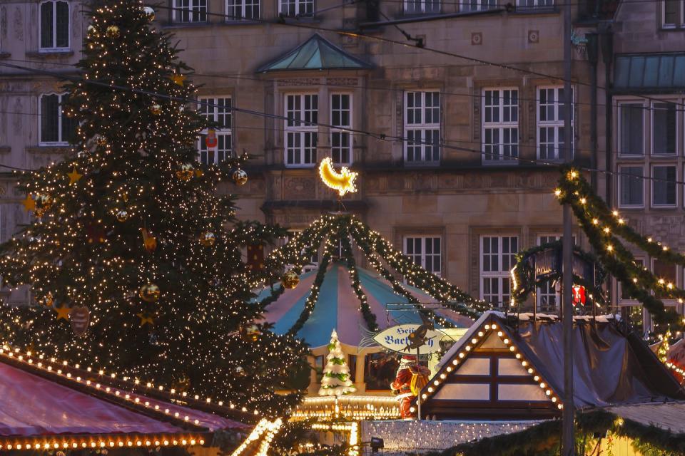 christmas market with stalls and a christmas tree