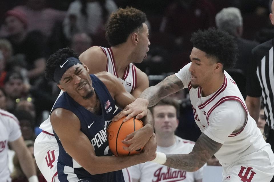 Penn State's Jalen Pickett, left, is fouled by Indiana's Jalen Hood-Schifino during the second half of an NCAA semifinal basketball game at the Big Ten men's tournament, Saturday, March 11, 2023, in Chicago. (AP Photo/Erin Hooley)