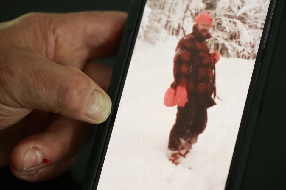 Larry Pfaff of Jacksonville holds up an undated photo of his father, Lawrence H. Pfaff Sr. The two had been estranged for about 30 years when the elder Pfaff died in June.