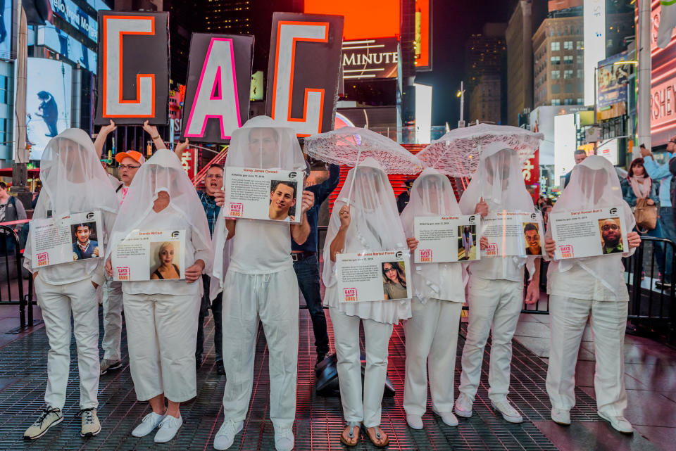 At the Gays Against Guns&nbsp;demonstration in New York after the Las Vegas massacre, shrouded&nbsp;participants carried photos of the victims. (Photo: Pacific Press / Getty Images)