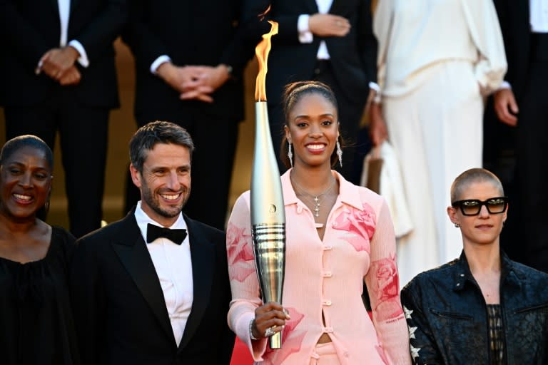 French basketball player Iliana Rupert (second right) was among those to carry the torch (LOIC VENANCE)