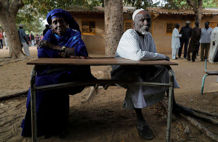 Voters sit on a school table as they wait for their turn to cast their votes during presidential election, at a polling station in Fatick, Senegal February 24, 2019. REUTERS/Zohra Bensemra