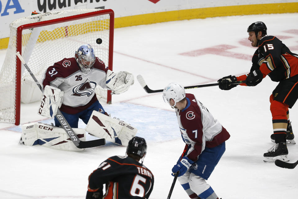 Colorado Avalanche goalie Philipp Grubauer (31) stops a shot by Anaheim Ducks forward Ryan Getzlaf (15) during the second period of an NHL hockey game in Anaheim, Calif., Friday, Jan. 22, 2021. (AP Photo/Ringo H.W. Chiu)