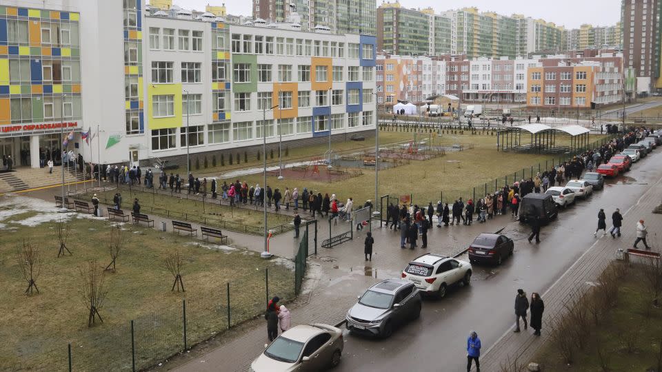 Voters queue at a polling station in St. Petersburg, Russia, at noon local time on Sunday. - AP