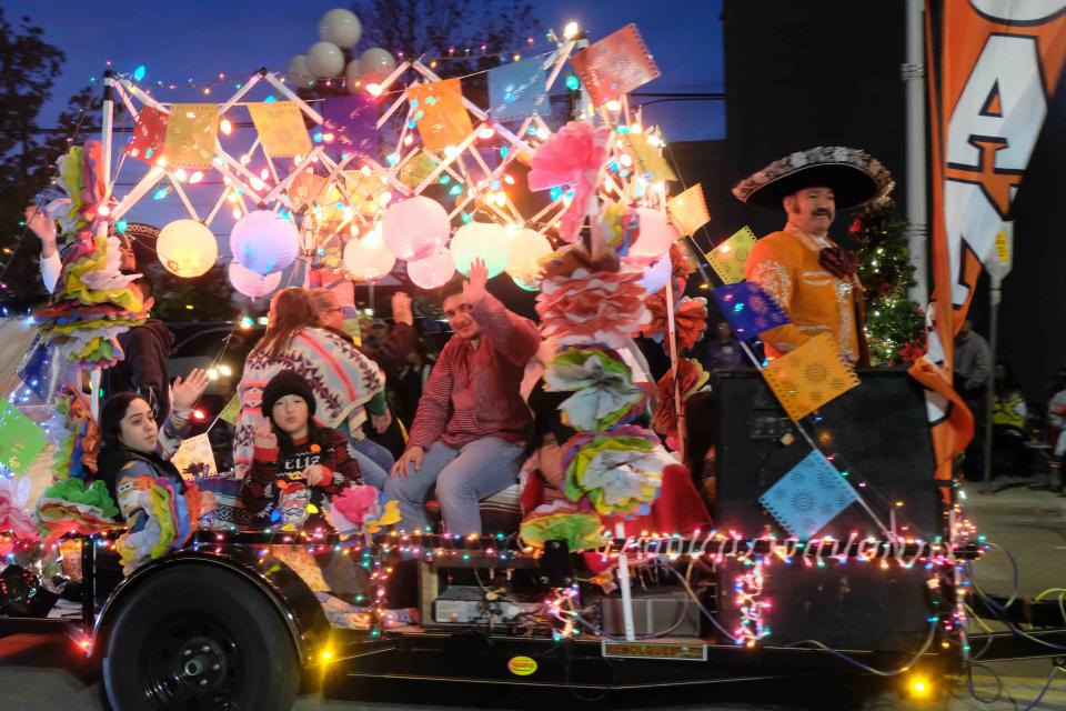 The festive Texan Credit Loan Company float rolls down Polk Street during Center City's Electric Light Parade Friday night in downtown Amarillo.