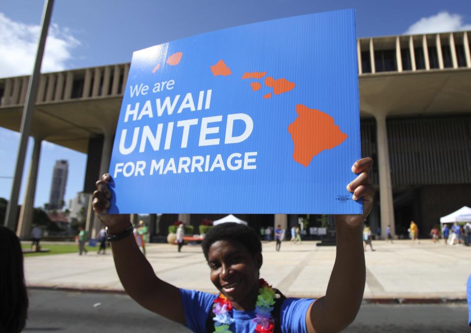 Sandra Johnson holds a sign in support of same sex marriage in front of the Hawaii State Capital in Honolulu