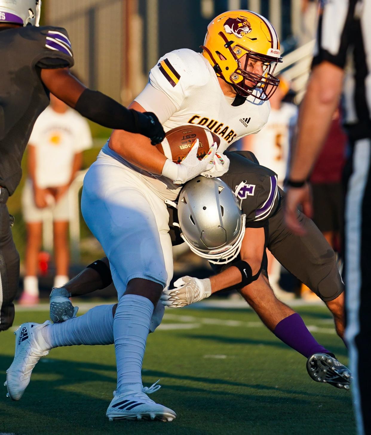 Bloomington North’s Aidan Steinfeldt (4) is tackled by Bloomington South’s Drew Crum-Hieftje during their football game at South on Friday, September 8, 2023.