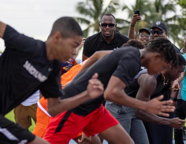 Olympic gold medalist Usain Bolt watches runners during an event at the Ansin Sports Complex on Saturday, July 15, 2023, in Miramar, Fla. Bolt was honored by the city of Miramar during the public event where a bronze sculpture of him was unveiled.