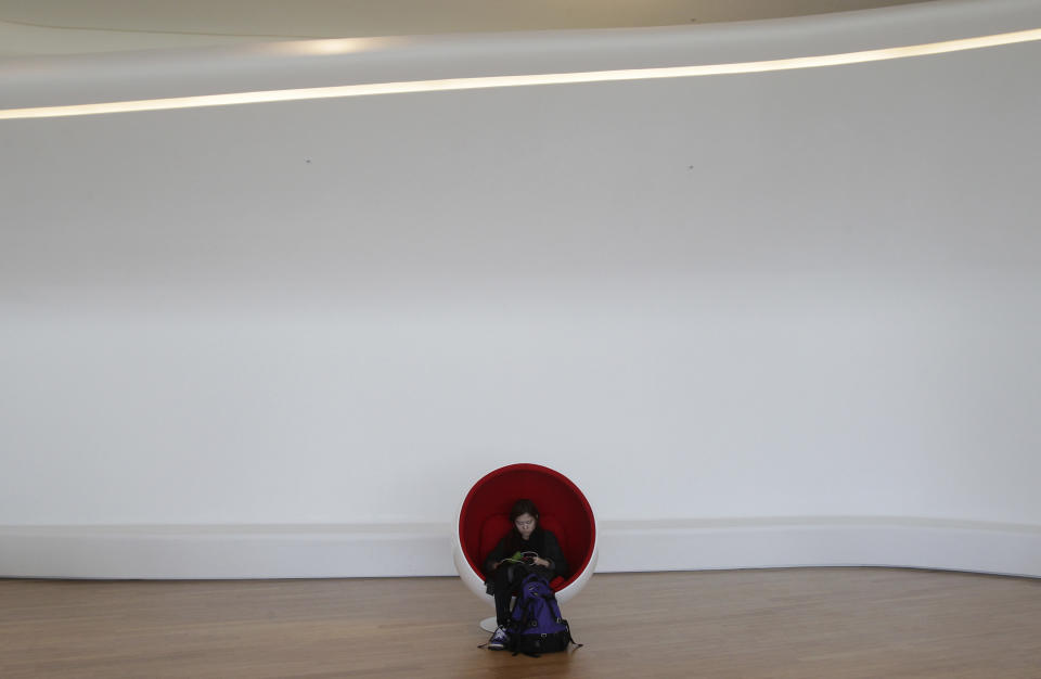 A visitor takes a rest at Dongdaemun Design Plaza in Seoul, South Korea, Friday, March 21, 2014. The $450 million building funded by Seoul citizen's tax money finally opened to public on Friday after years of debates about transforming a historic area with an ultra-modern architecture. (AP Photo/Ahn Young-joon)