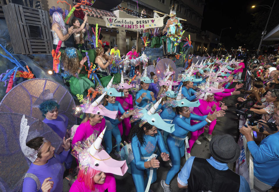 In this Saturday, Oct. 28, 2023, photo provided by the Florida Keys News Bureau, a group depicting an offbeat Kentucky Derby for unicorns performs on Duval Street during the Fantasy Fest Parade in Key West, Fla. The elaborate procession of floats and costumed marchers highlighted the 10-day Fantasy Fest costuming and masking festival, themed "Uniforms and Unicorns," that ends Sunday, Oct. 29. The Derby takeoff, produced by a group dubbed the Lower Keys Fluffers, was named the parade's best overall entry. (Andy Newman/Florida Keys News Bureau via AP)