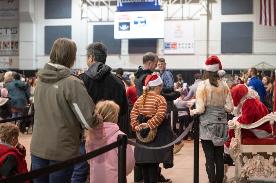 Families wait in line to visit Santa during the Winter Wanderland event at Kellogg Arena on Friday, Dec. 2, 2022.