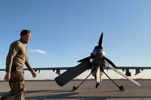 A US soldier walks past a drone at the Ain al-Asad airbase in the western Iraqi province of Anbar